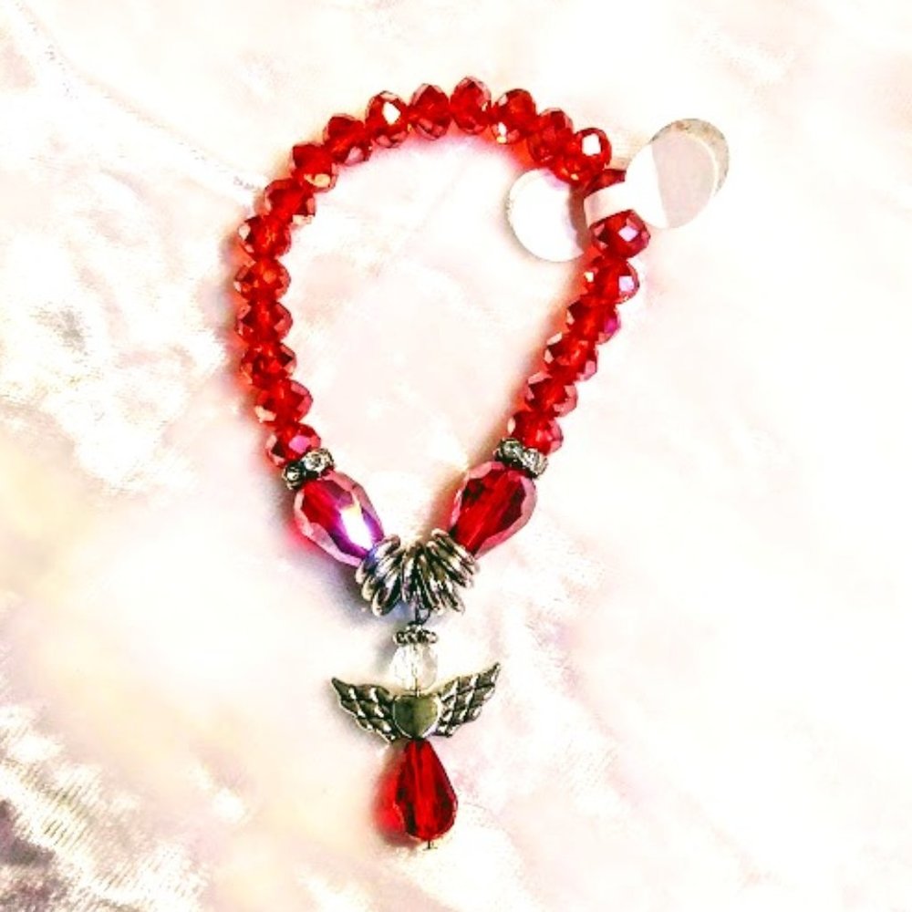 RED FACETED CZECH GLASS ELASTIC BRACELET WITH A SWEET ANGEL CHARM
